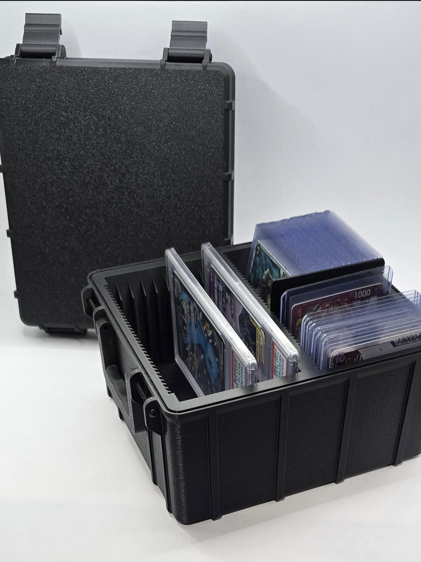 Open custom card case holding PSA slabs and toploaders