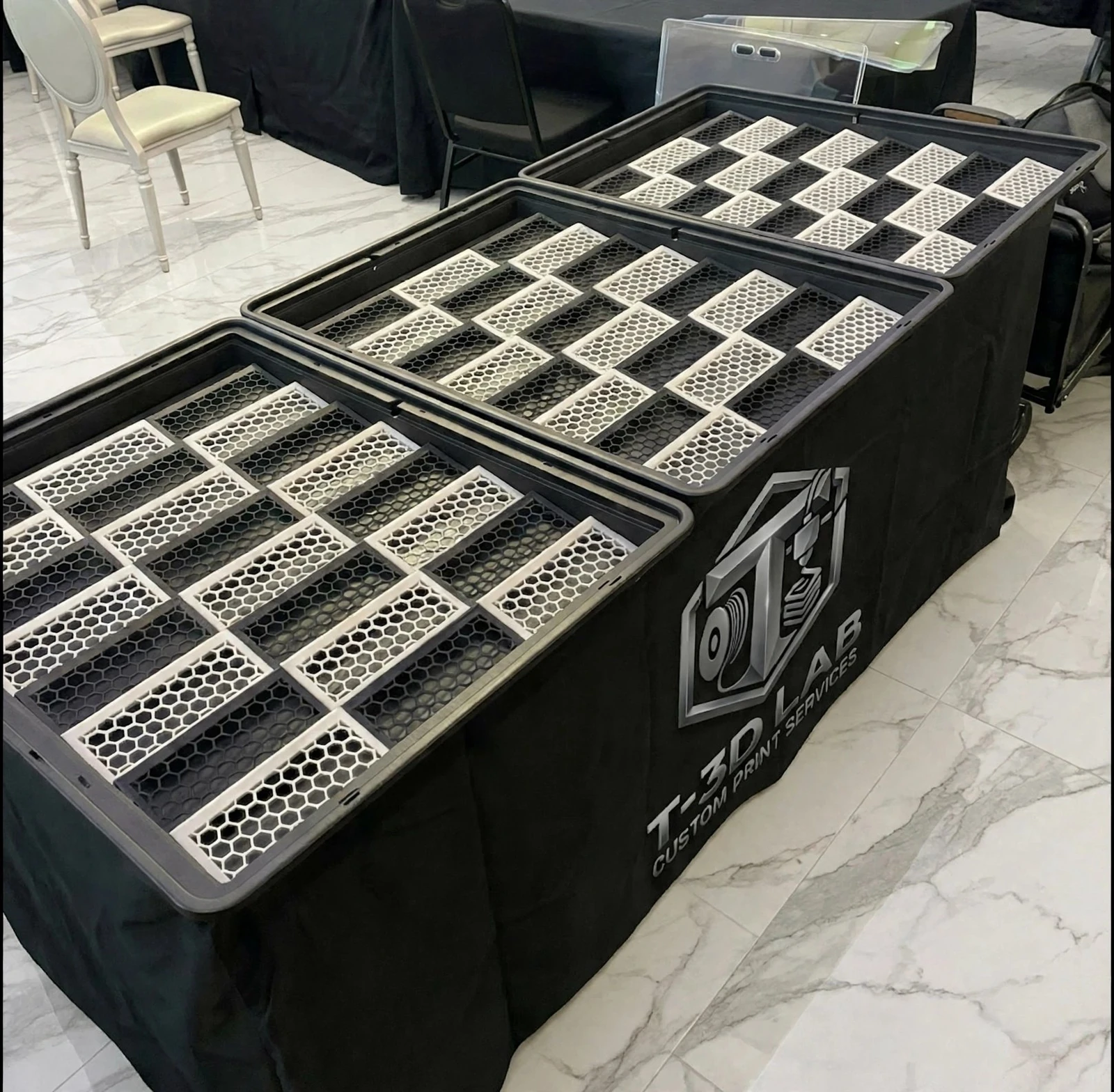 Multiple card display cases fitted with T-3D LAB risers at a table