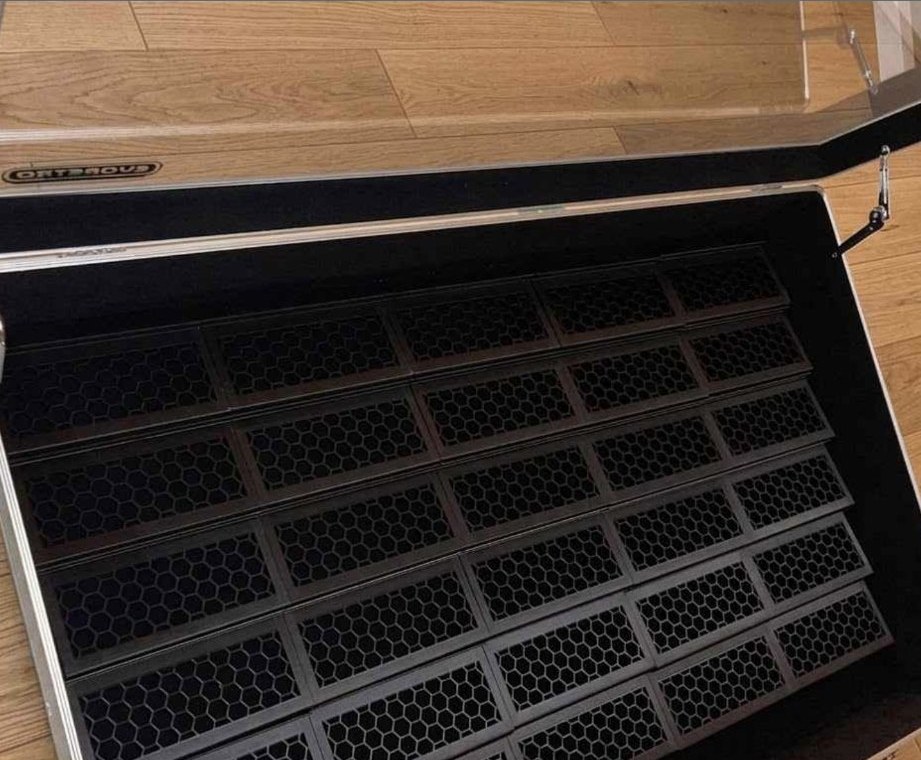 Black slab risers arranged five across and six rows high inside an Evoretro 36 by 24 card case
